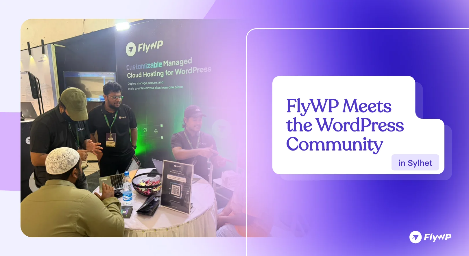 FlyWP Meets the WordPress Community in Sylhet: FlyWP team members talking with a visitor at the FlyWP booth