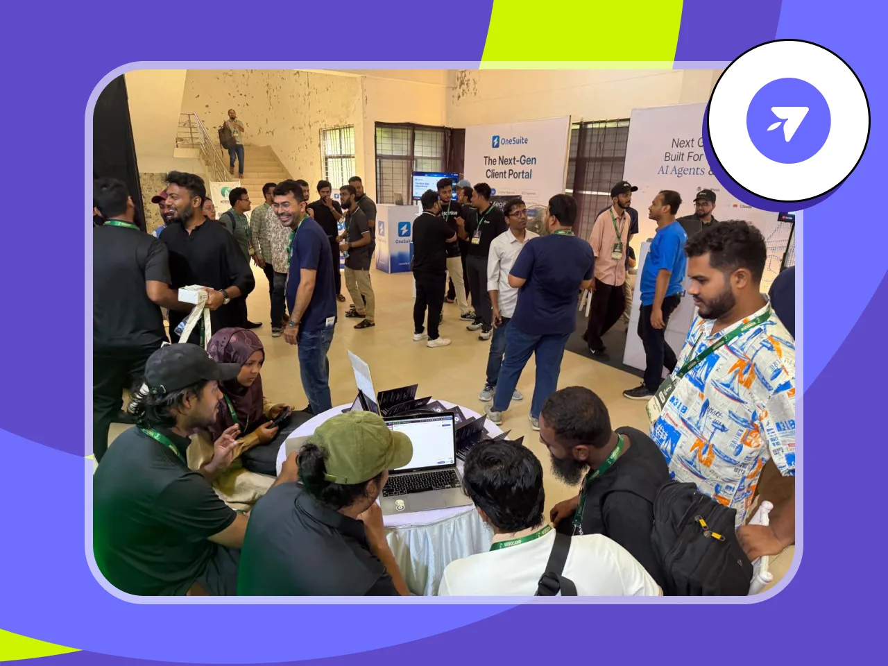 Attendees and FlyWP team members gathered around a laptop on the booth table